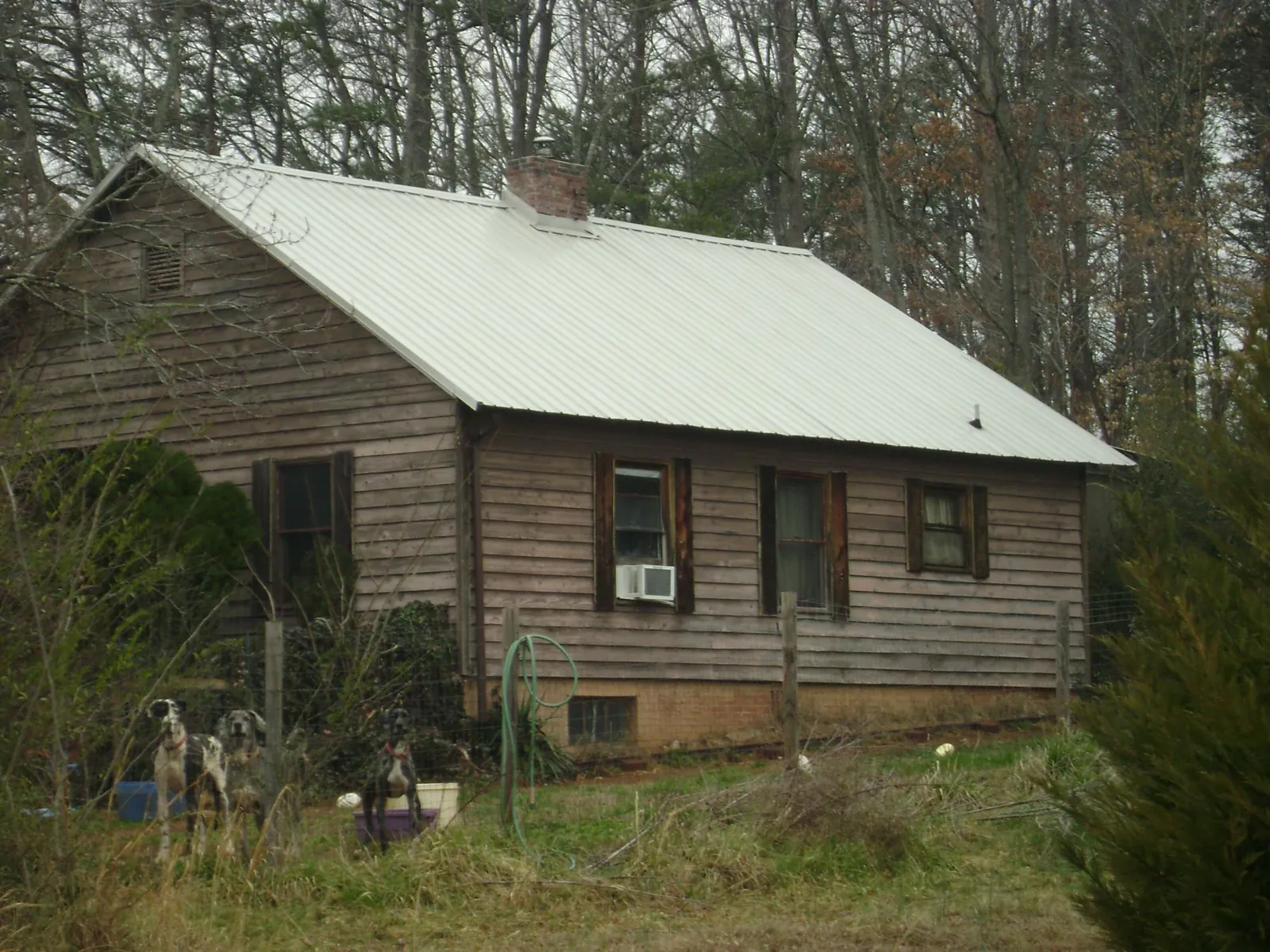White metal roof on an old wood sided farmhouse, from a Metal Roof Installation job in Hawley
