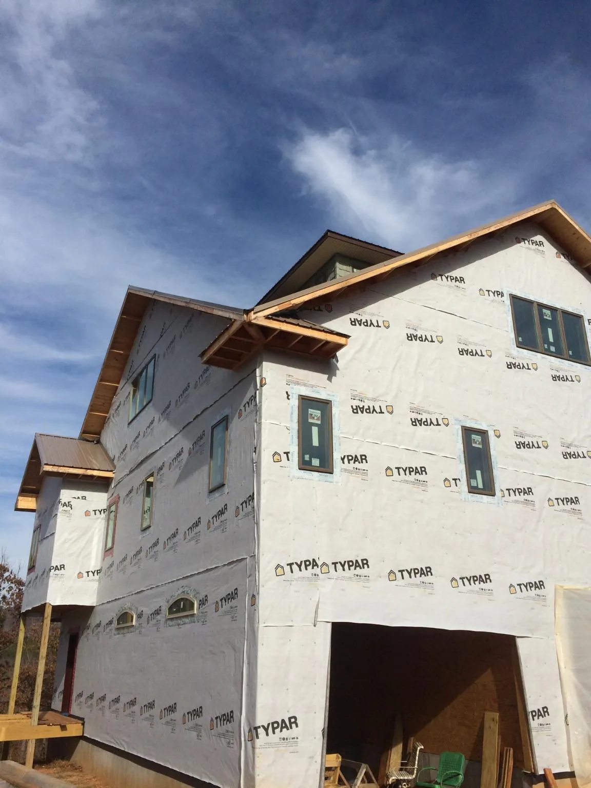 Stick built house wrapped in Typar with new roof framing and dormers in Hawley